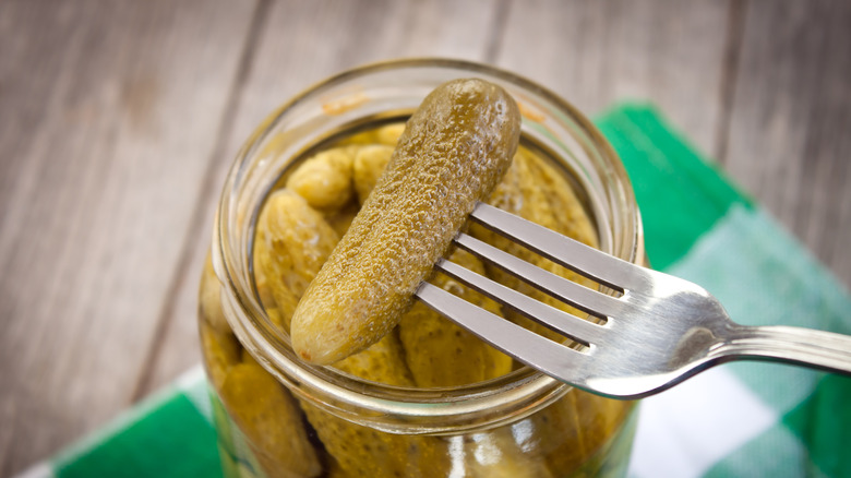 Pickles with fork in jar