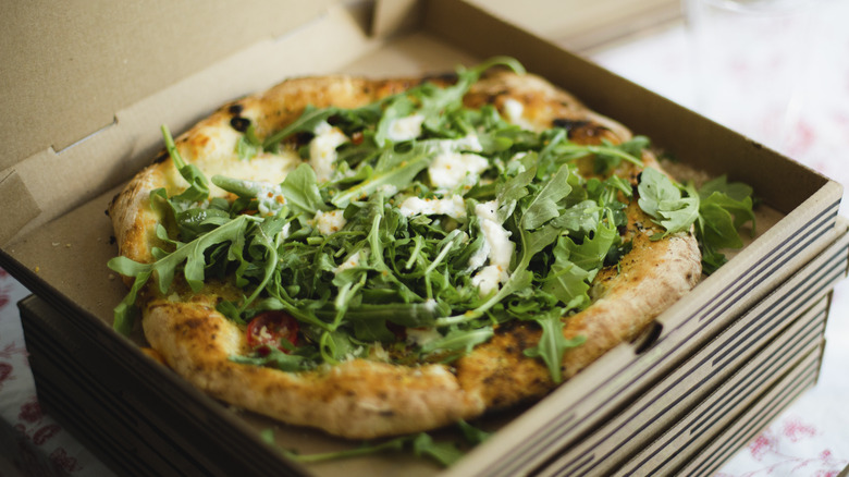 pizza with heaping arugula