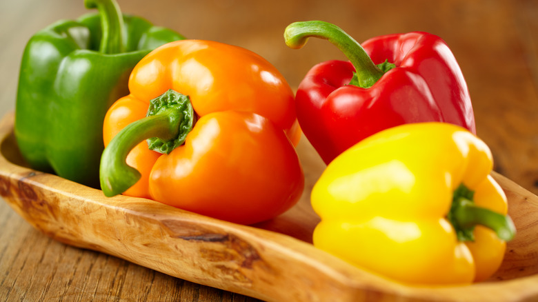 bell peppers in wooden bowl