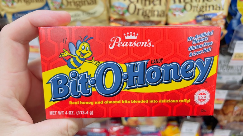 Hand holding a box of Bit-O-Honey