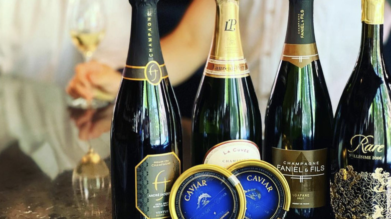 Bottles of champagne with caviar