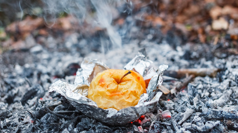 Apple in foil on coals