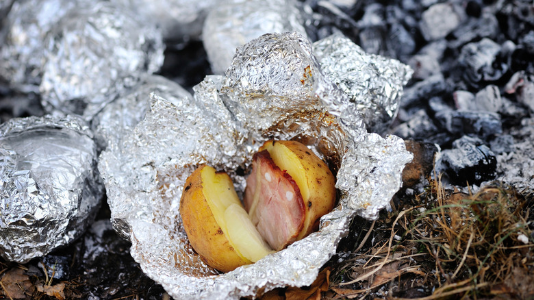 Potato in foil on coals