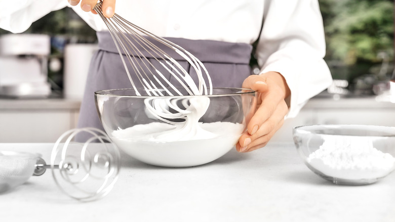 Person whipping cream in bowl