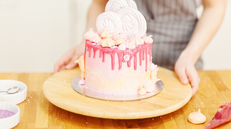 Person showing decorated cake