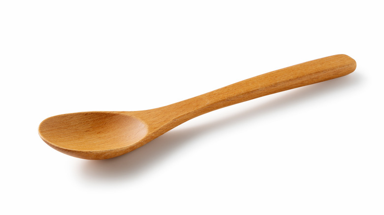 Wooden spoon on white background