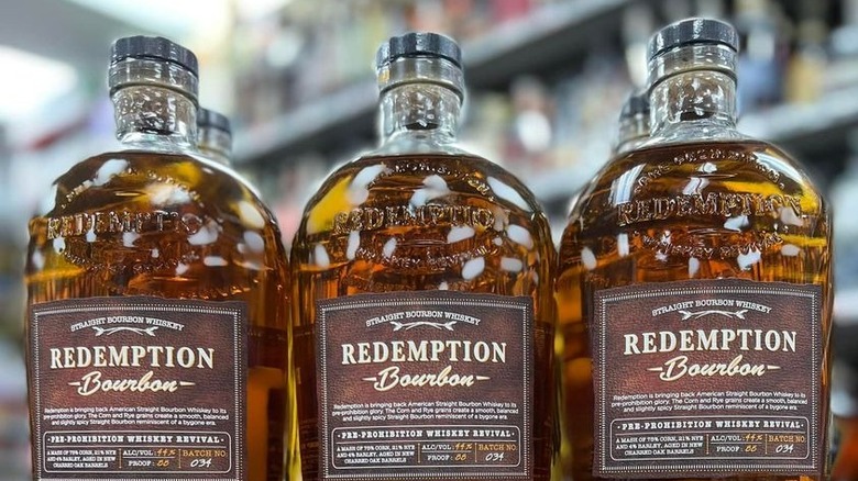 three redemption whiskey bottles