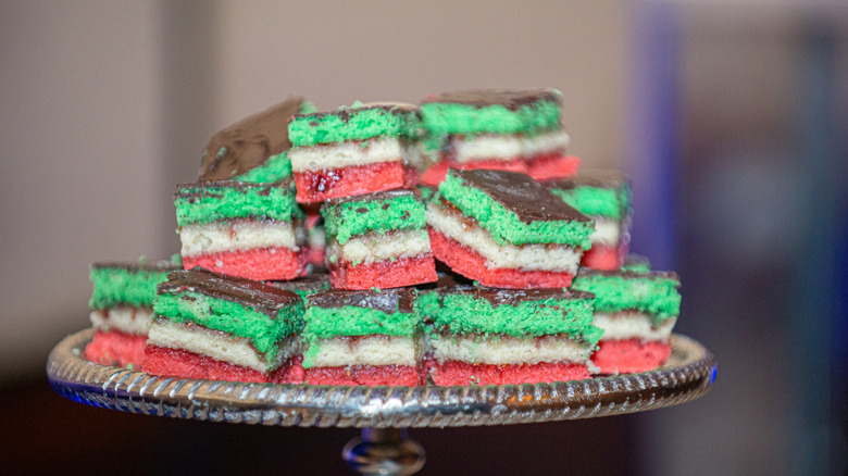 Italian rainbow cookies stacked on platter