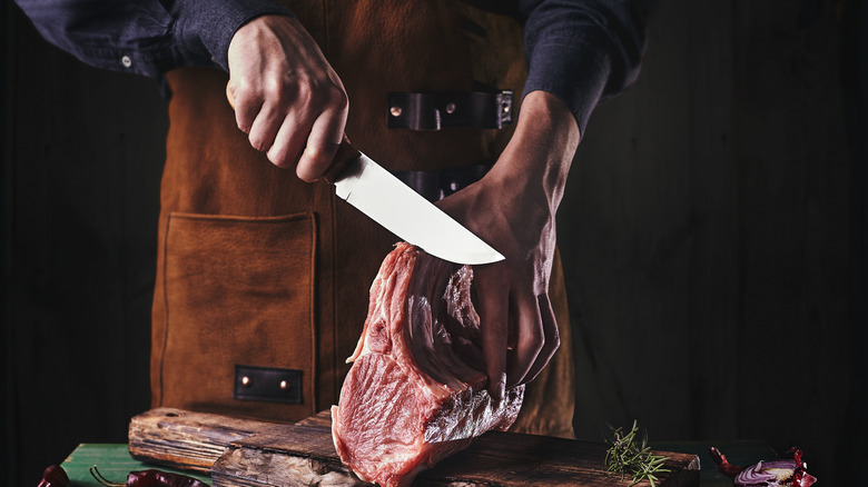 Boning knife cutting ribbed meat