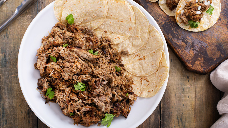 carnitas on plate with tortillas