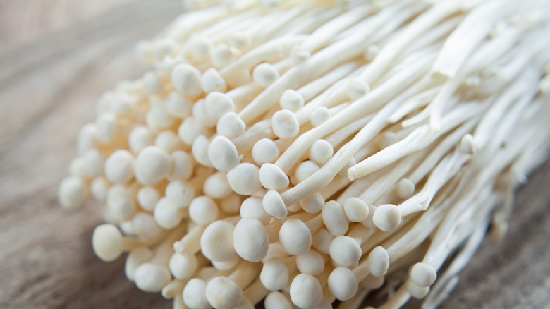 Enoki mushrooms on wooden table