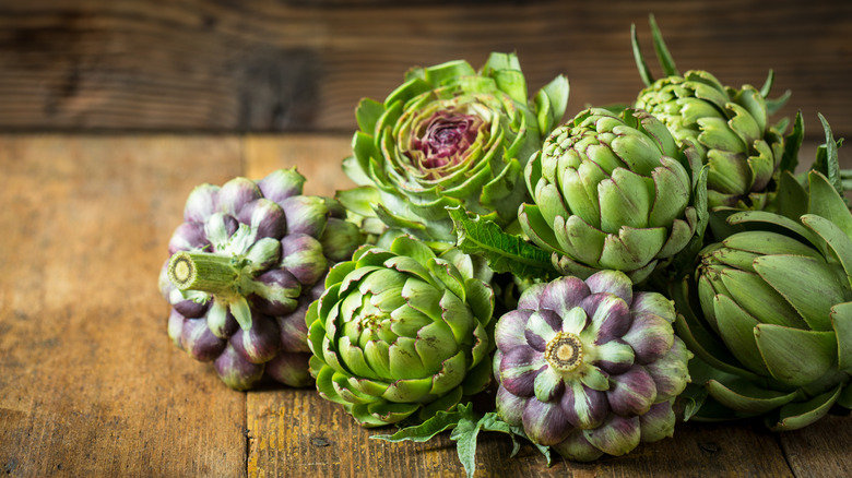 artichokes on wooden surface