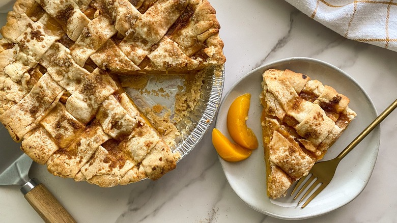 sliced peach pie on plate 