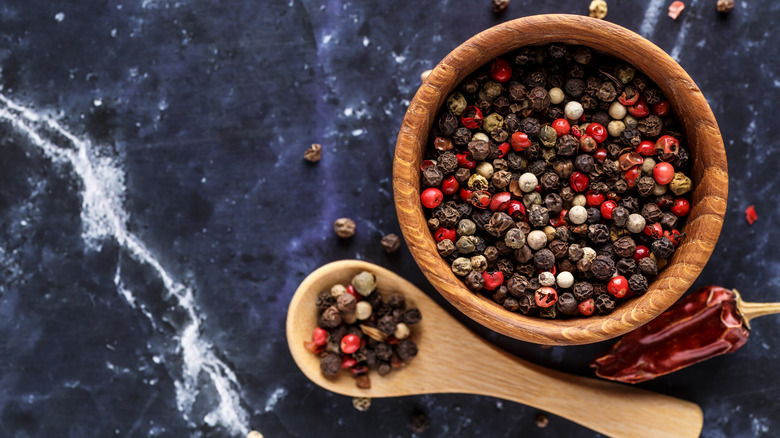 wooden bowl with mixed peppercorns