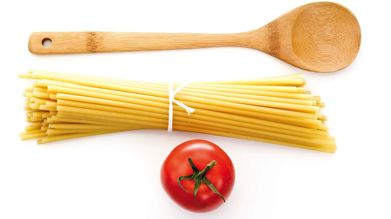 Wooden spoon and pasta ingredients