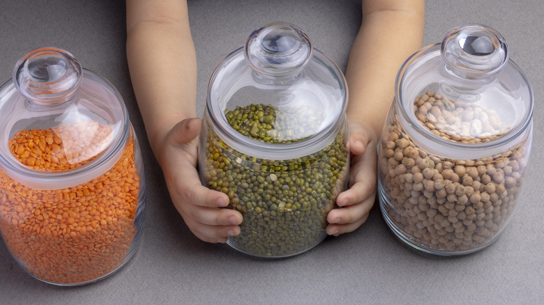 Jars of legumes on table