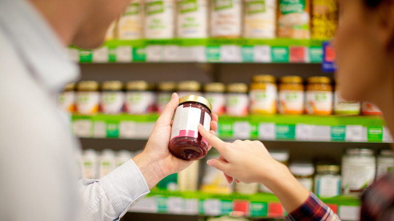 Person examining jar label