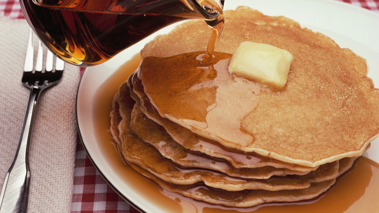 Stack of pancakes with butter and syrup
