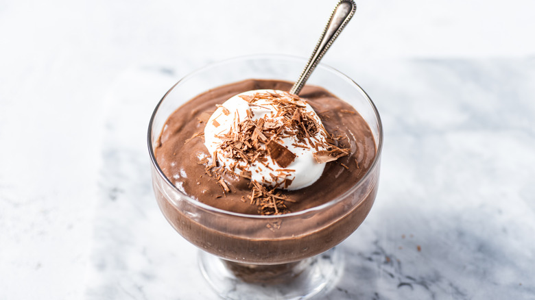 Bowl of pudding with whipped cream and chocolate shavings