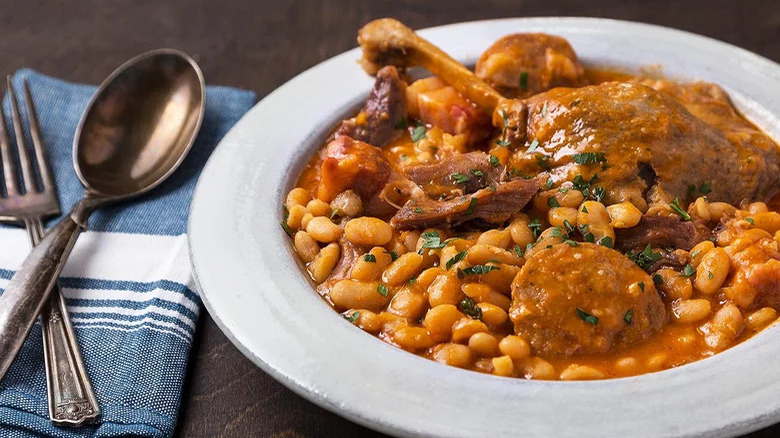 Duck cassoulet in white bowl