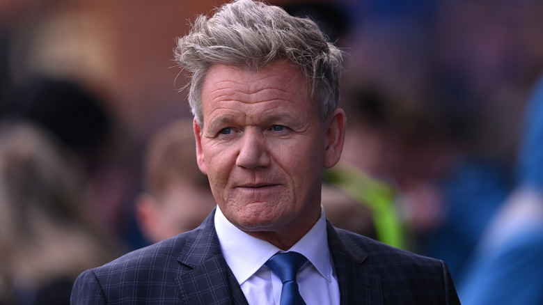 Gordon Ramsay in a suit and tie with a blurred background