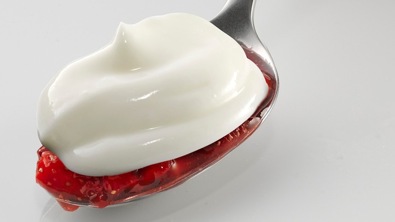 spoon with sour cream and strawberry