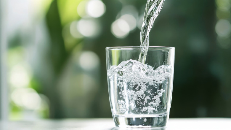 pouring water into glass outside