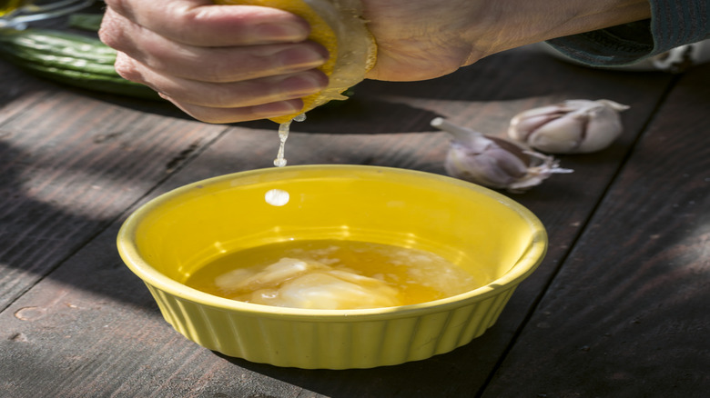 hand squeezing lemon juice