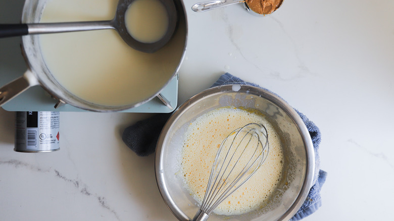 Tempering yolks into milk