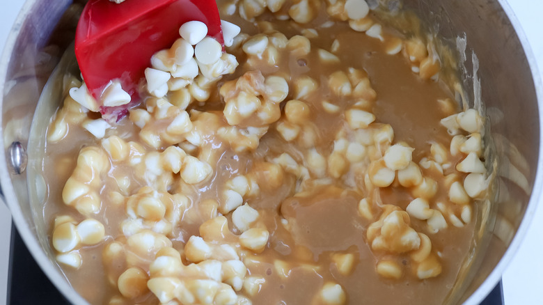 stirring white chocolate into caramel