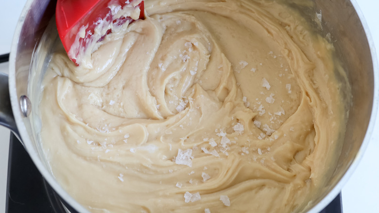 stirring flaky salt into caramel