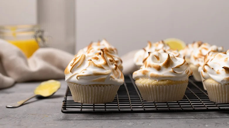 Lemon meringue cupcakes on rack