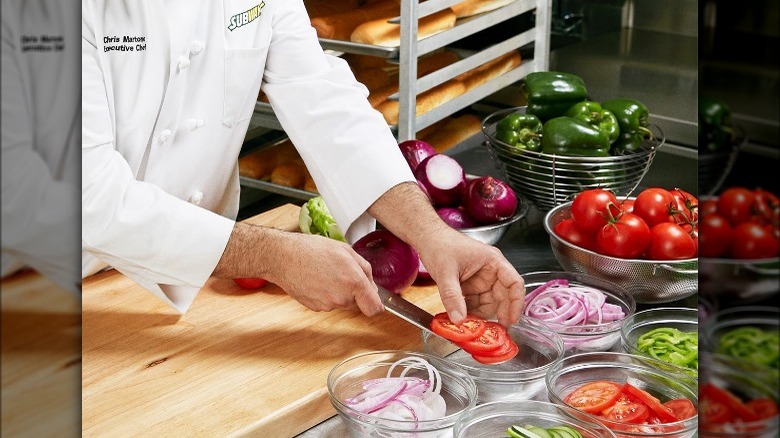 Subway chef chopping vegetables