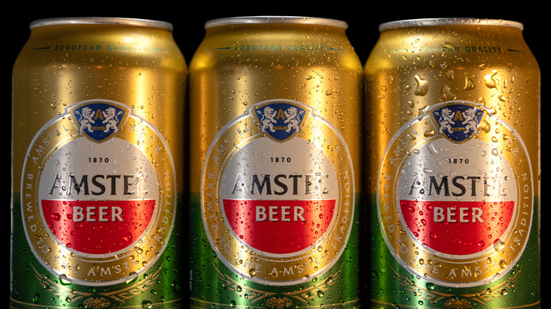 three cans of Amstel Beer 