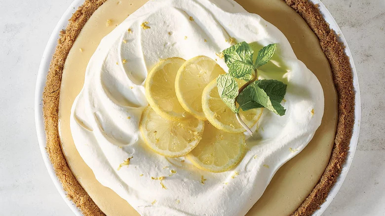 Easy Lemon Pie with whipped cream, lemon slices, and a sprig of mint