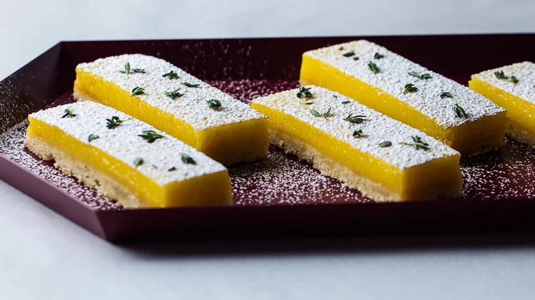 Lemon-Thyme Bars with confectioner's sugar topping and thyme leaf garnish