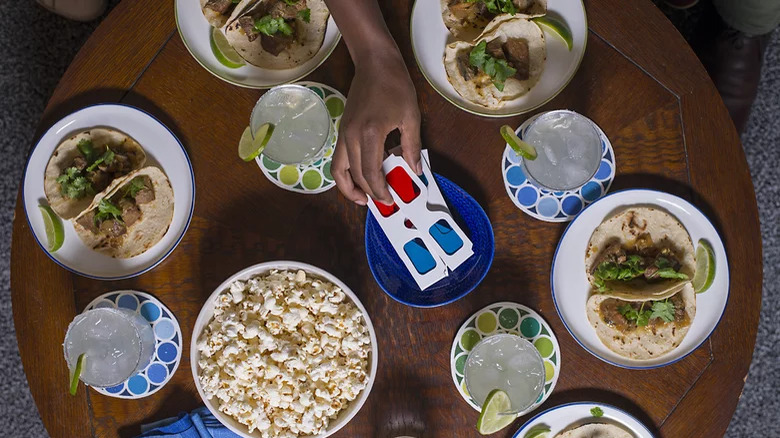 A coffe table filled with pork and lime tacos for movie night