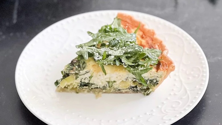 Quiche topped with salad