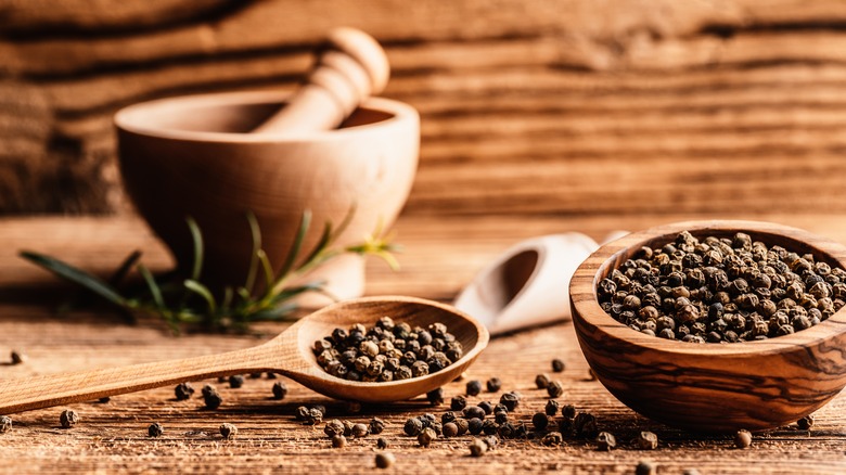 Peppercorns in bowl and spoon