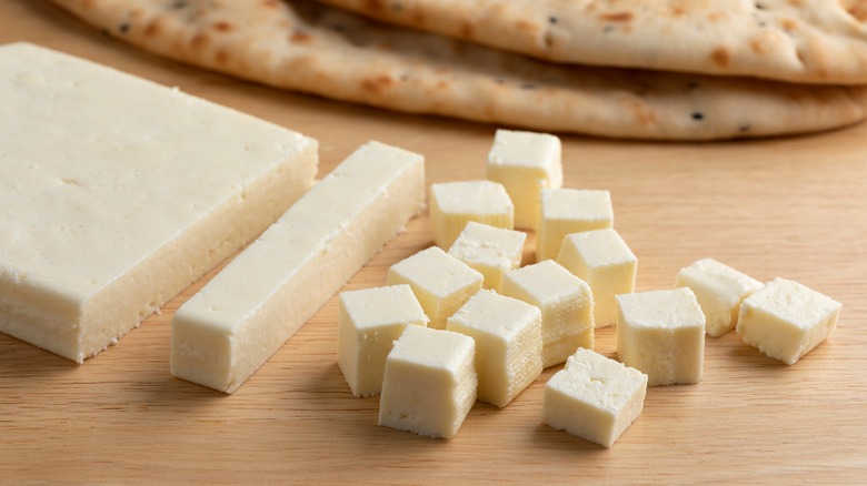 Chopped paneer on chopping board