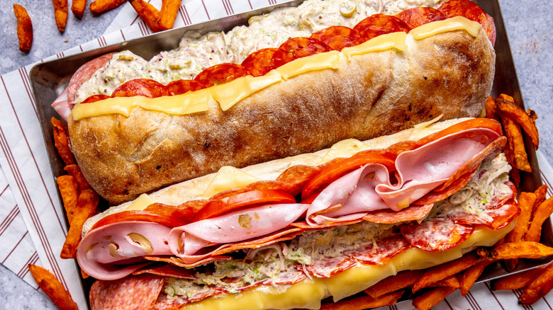 sub sandwiches stuffed with pepperoni, mortadella, cheese, tomatoes and more