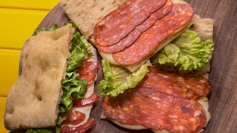 panini sandwich with soppressata, lettuce and tomatoes