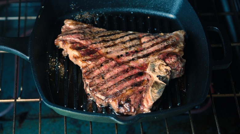 steak in skillet in oven