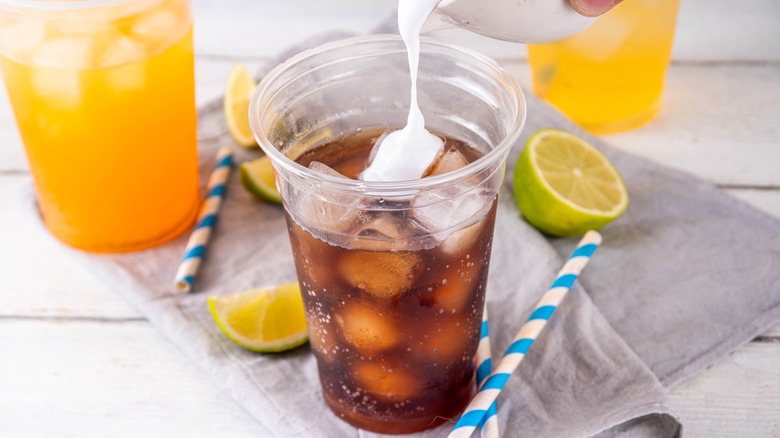 Cream pouring into soda