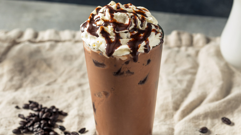 Whipped cream and chocolate syrup topped mocha latte