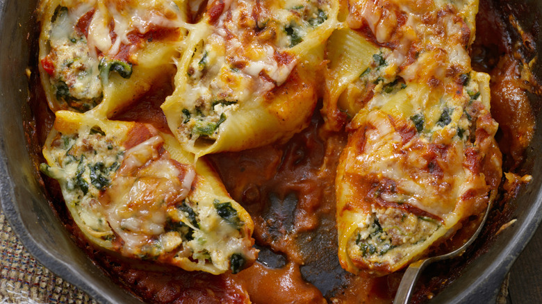 large shell pasta stuffed with cheese, sauce, and vegetables