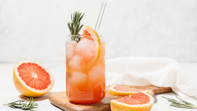 tropical fruit juice drink with sliced grapefruits and rosemary