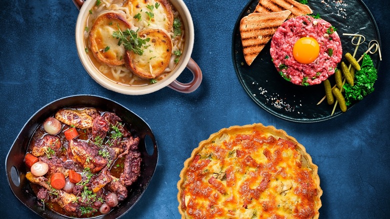 Overview of four French dishes on a blue surface