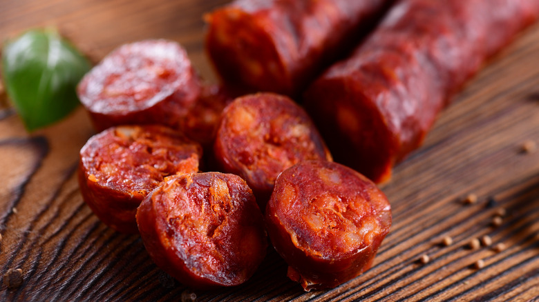 cured Spanish chorizo sliced on wooden board