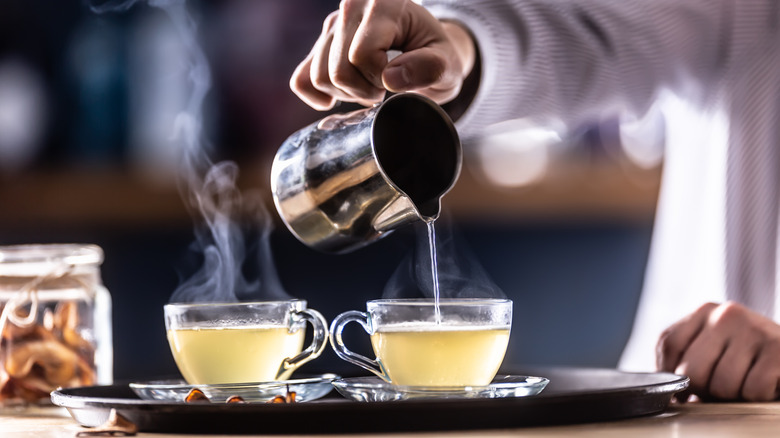 bartender serving two simple hot toddies